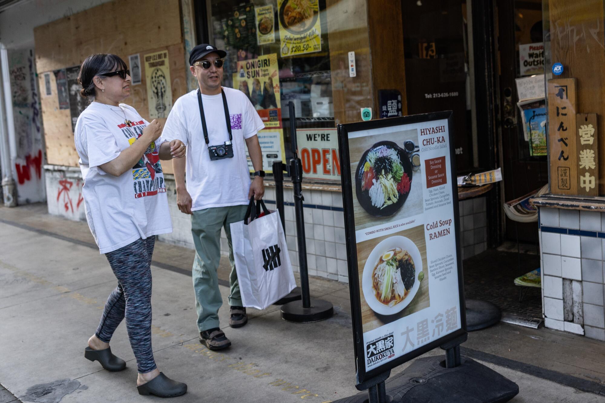 Julia M. Leonard and Kevin Uyeda of the Echo Park await a table in Daikokuya in Little Tokyo.
