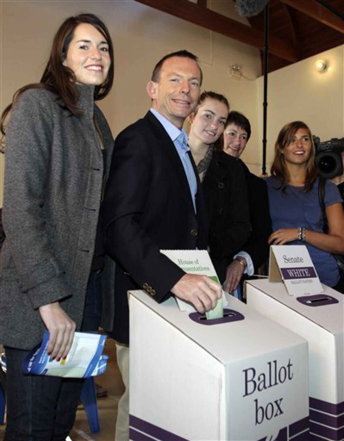 Australia's opposition leader Tony Abbott, 2nd left, with his daughter Louise, left, Frances, 3rd left, Bridget, right, and wife Margie votes at Queenscliff Beach polling station in Sydney, Australia, Saturday, Aug. 21, 2010. (AP Photo/Rob Griffith)