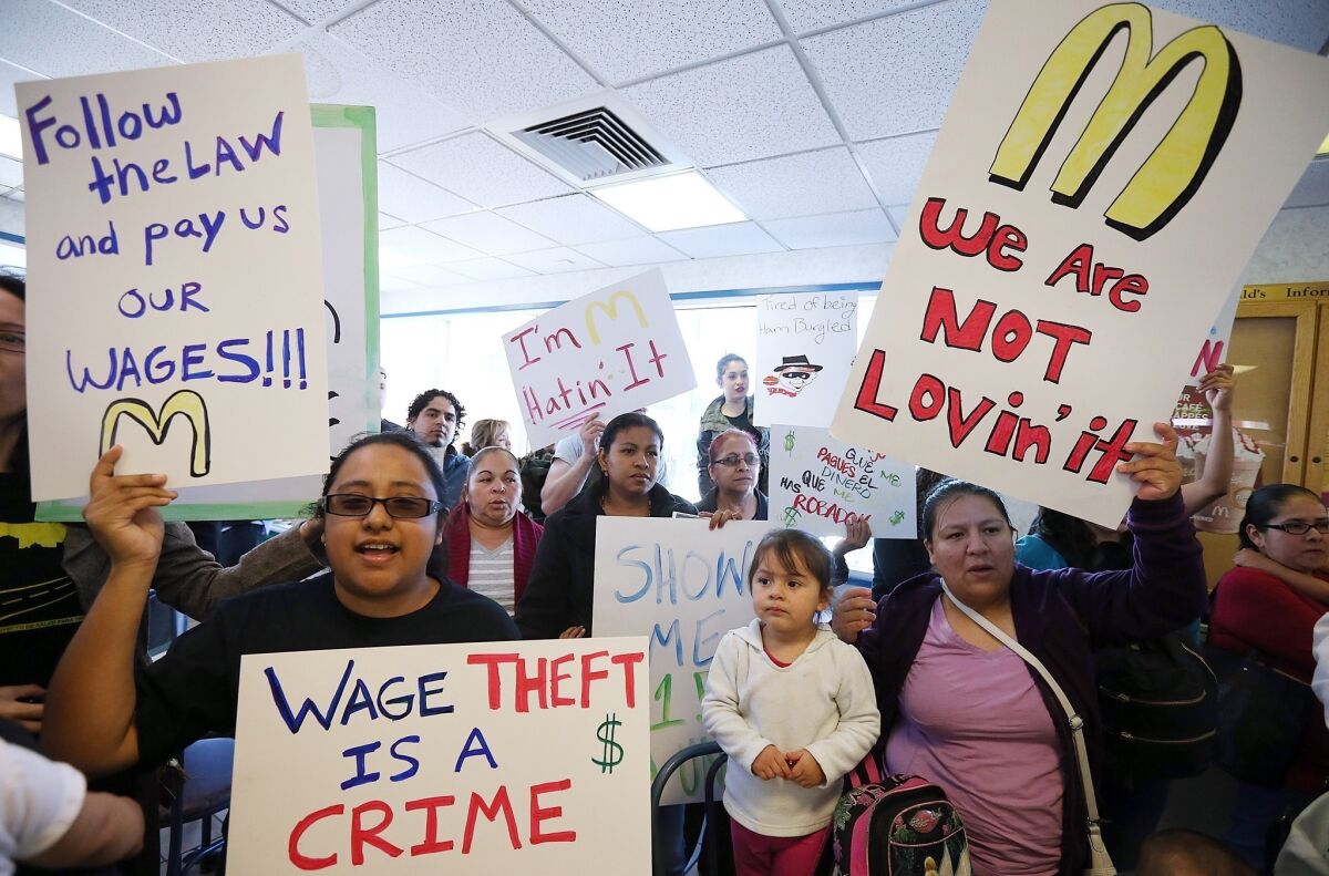 Fast-food workers and activists protest inside a McDonald's restaurant in Oakland.
