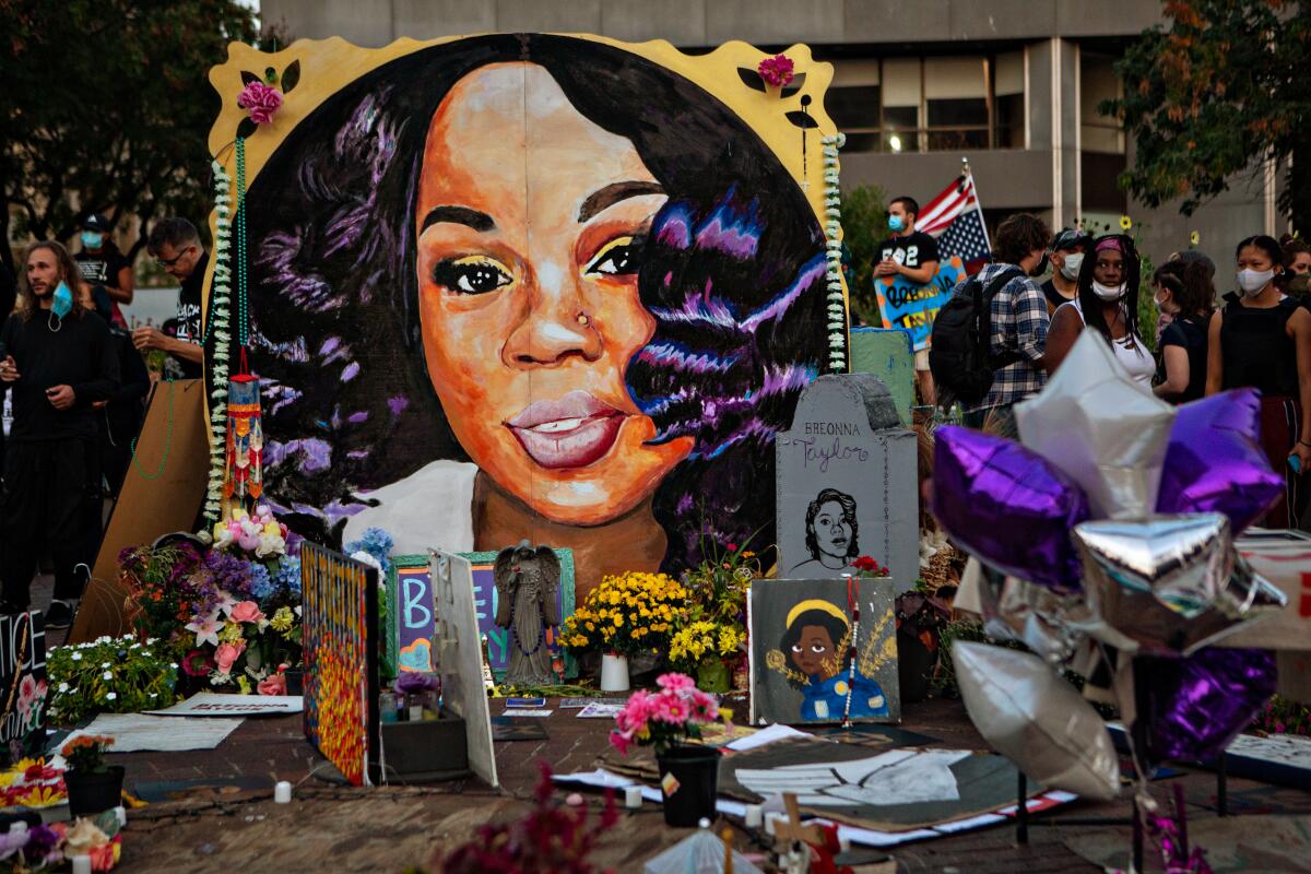 People gather at a memorial for Breonna Taylor in downtown Louisville, Ky., in 2020.