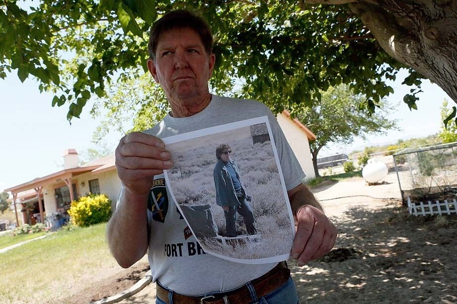 Ben Devitt holds a photo of his wife, Pamela Maria Devitt, who was killed by a pack of pit bulls May 9 in Littlerock.