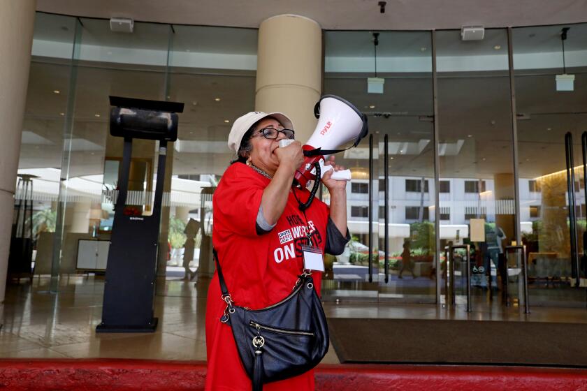 BEVERLY HILLS, CA - JULY 24: Nelly Anaya-Mena, a housekeeper at the Beverly Hilton, along with other Southern California hotel workers walk out and strike at the Beverly Hilton on Monday, July 24, 2023 in Beverly Hills, CA. (Gary Coronado / Los Angeles Times)