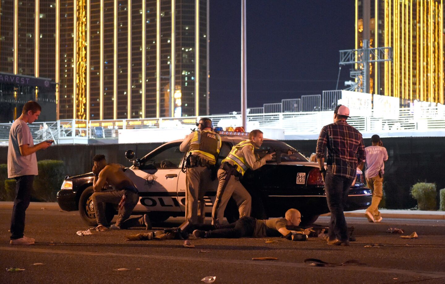 Las Vegas police work on a street outside the grounds of the Route 91 Harvest country music festival in Las Vegas on Sunday night.