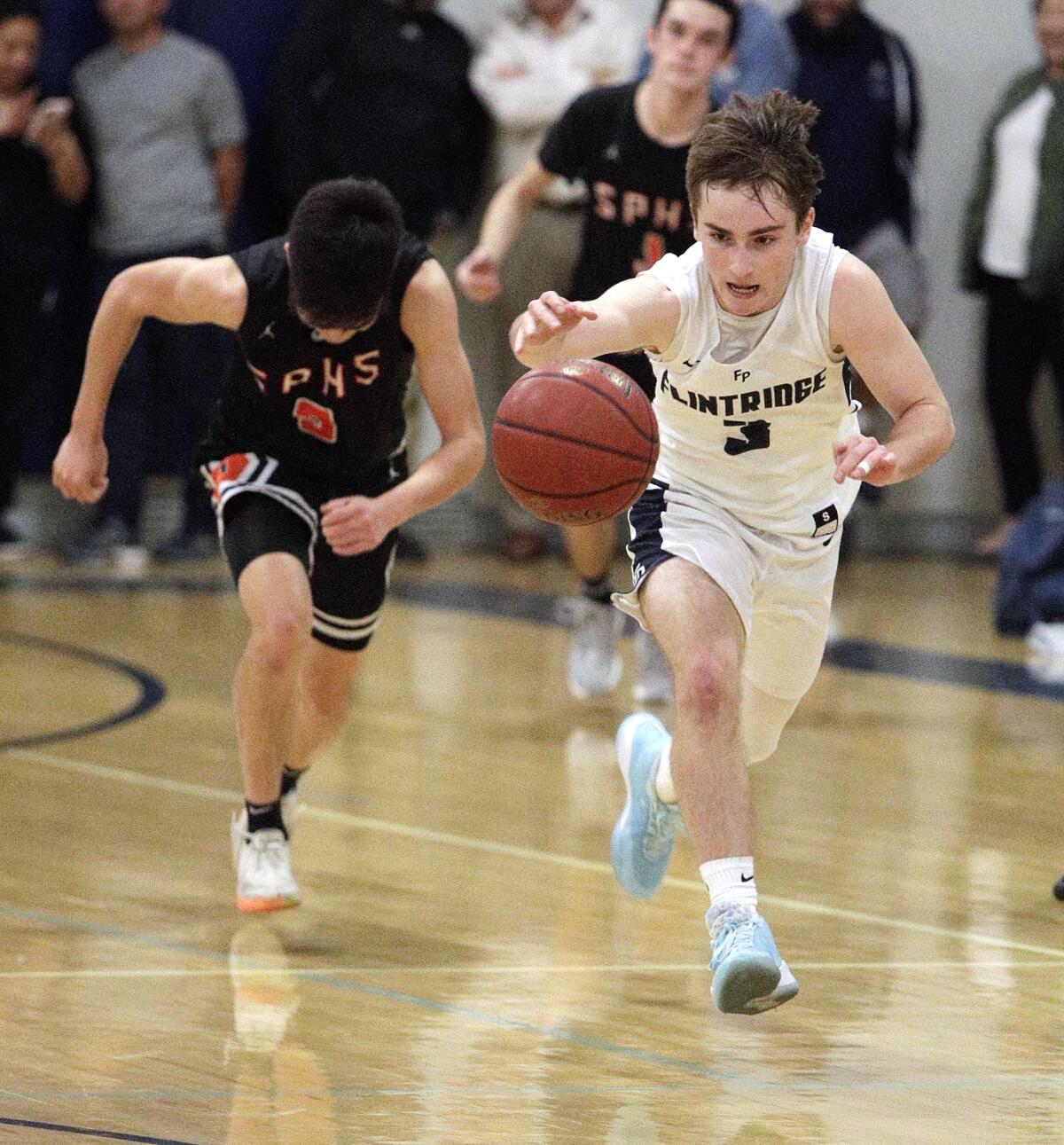 Flintridge Prep's Kevin Ashworth takes off with the ball after stealing it form South Pasadena's Preston Sharkey in a non-league boys' basketball game at Flintridge Preparatory School on Monday, January 6, 2020.