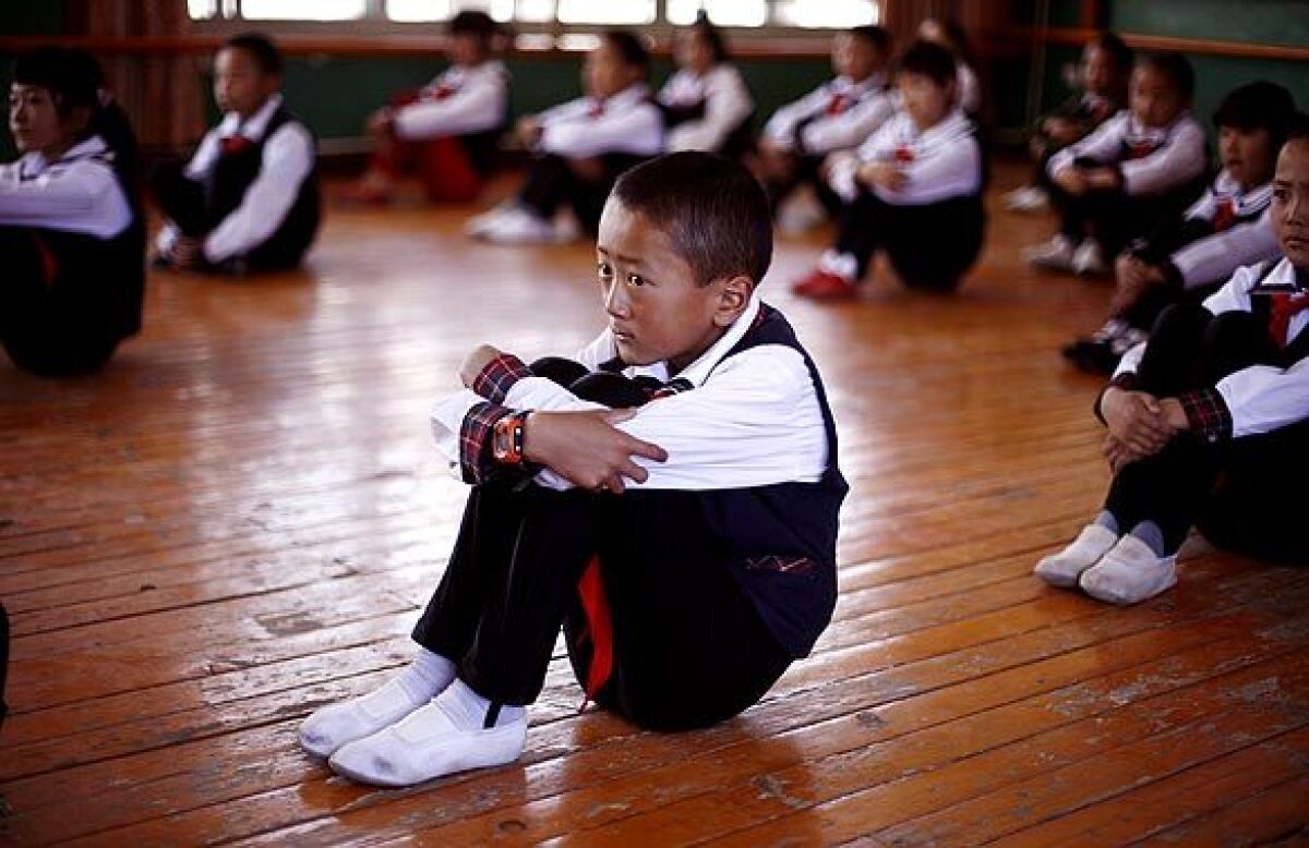 Tibetan students sit in dance class at school in Tibet