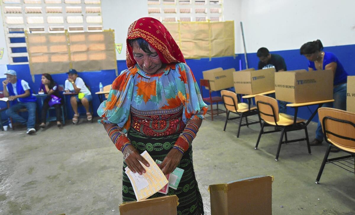 A woman casts her vote at a polling station in Veracruz, outside Panama City, during Panama's presidential election.