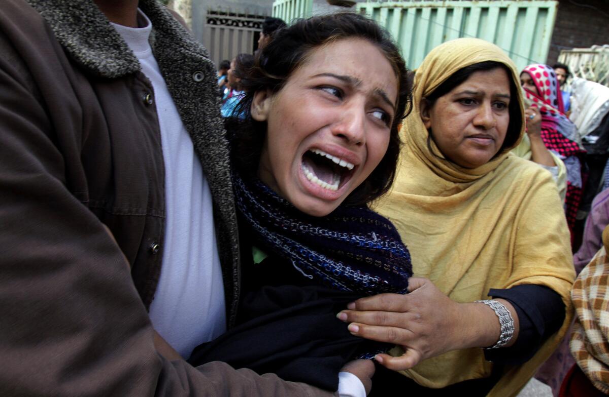 A Pakistani Christian woman mourns over a relative killed in an attack near two churches in Lahore.