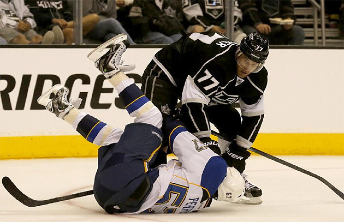L.A. Kings' Jeff Carter checks St. Louis Blues' David Perron during the second period