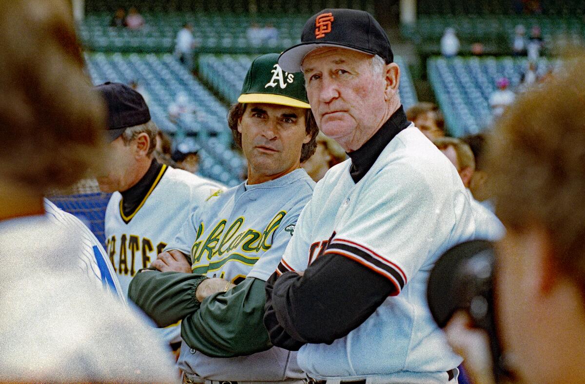 San Francisco Giants manager Roger Craig, right, speaks with Oakland Athletics manager Tony La Russa.
