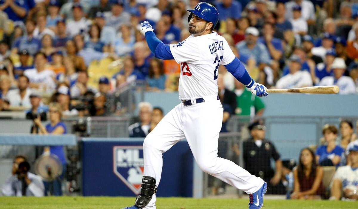 Dodgers' Adrian Gonzalez hits an RBI single in the eighth inning against the New York Mets in Game 1 of the National League division series Friday.