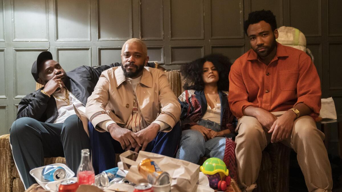 Three men and a woman sit on a couch in “Atlanta.”