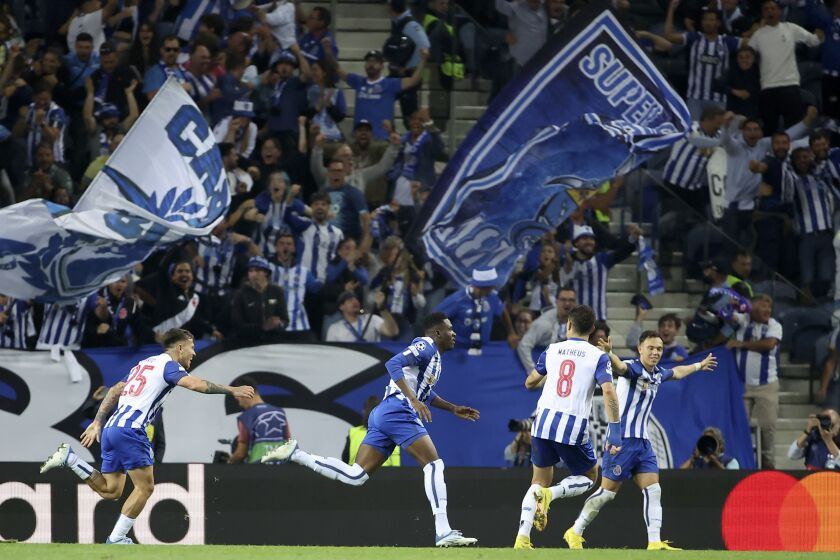 Porto's Zaidu Sanusi, center, celebrates after scoring the opening goal during a Champions League group B soccer match between FC Porto and Bayer 04 Leverkusen at the Dragao stadium in Porto, Portugal, Tuesday, Oct. 4, 2022. (AP Photo/Luis Vieira)
