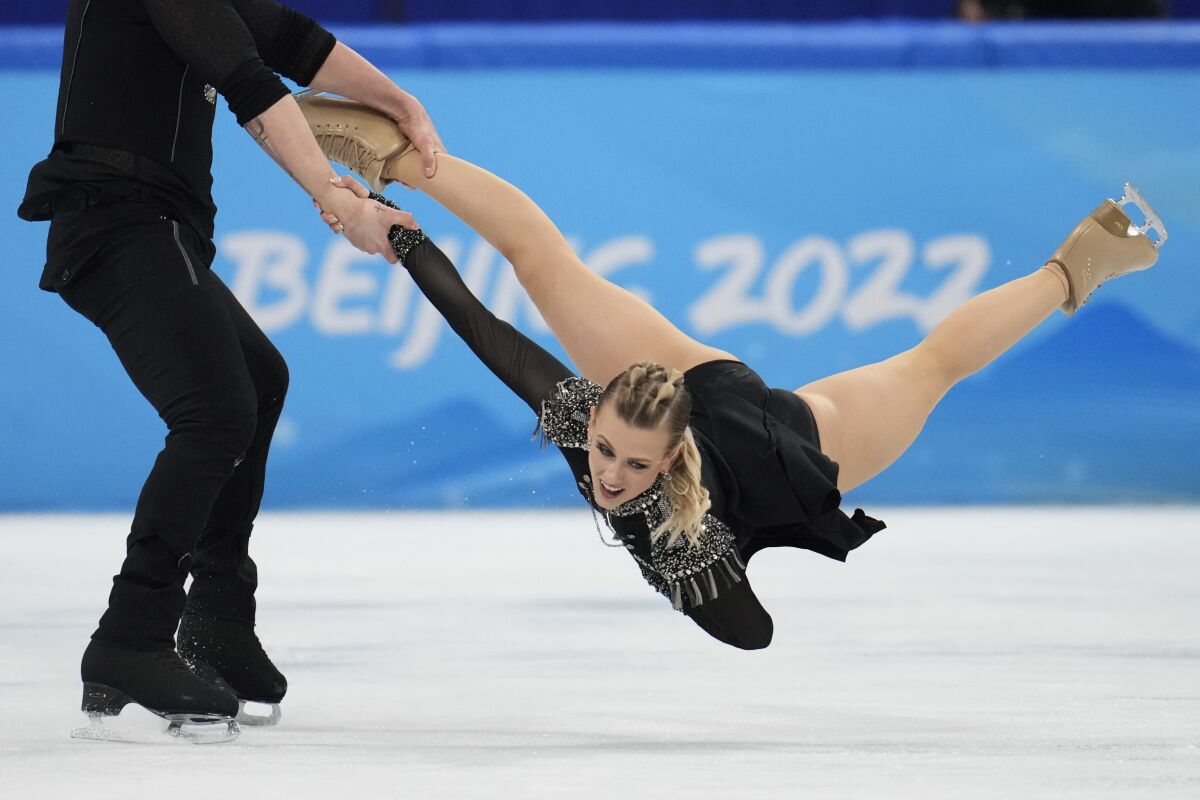 Madison Hubbell and Zachary Donohue, of the United States, perform their routine in the ice dance competition during figure skating at the 2022 Winter Olympics, Saturday, Feb. 12, 2022, in Beijing. (AP Photo/Natacha Pisarenko)