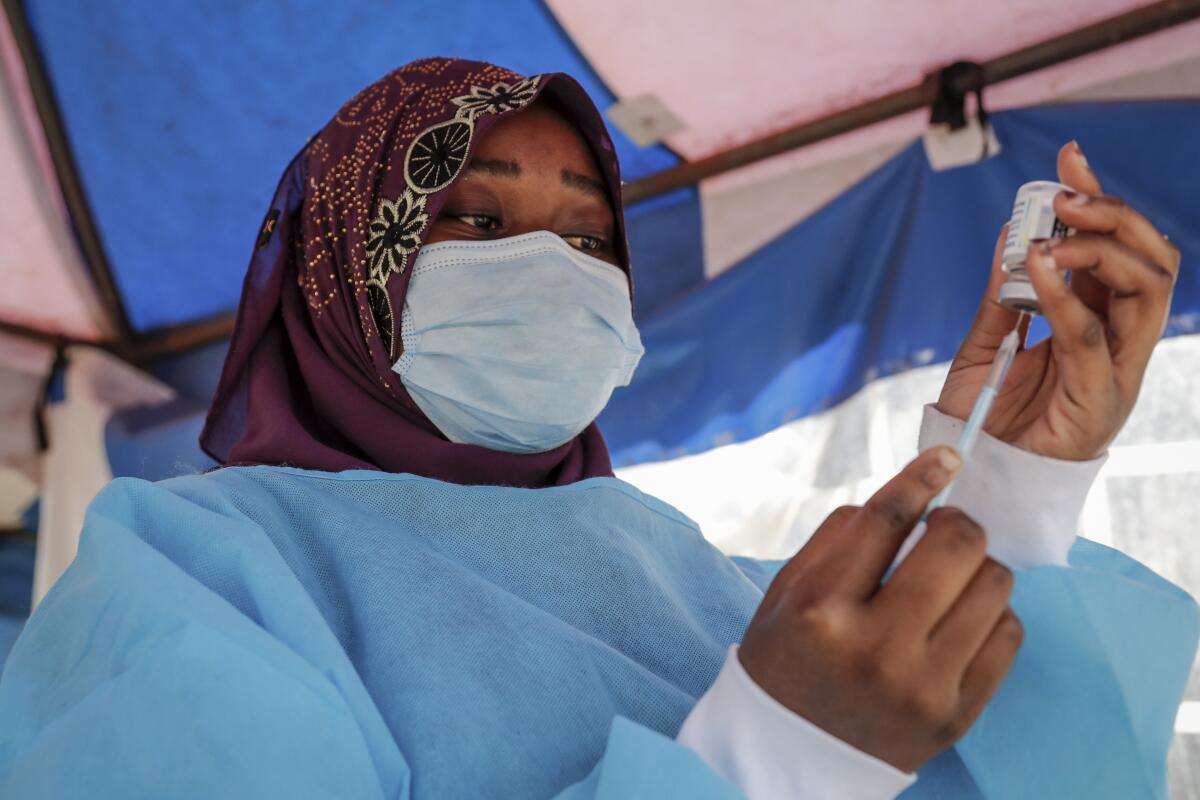 A nurse prepares a dose of vaccine in Nairobi.