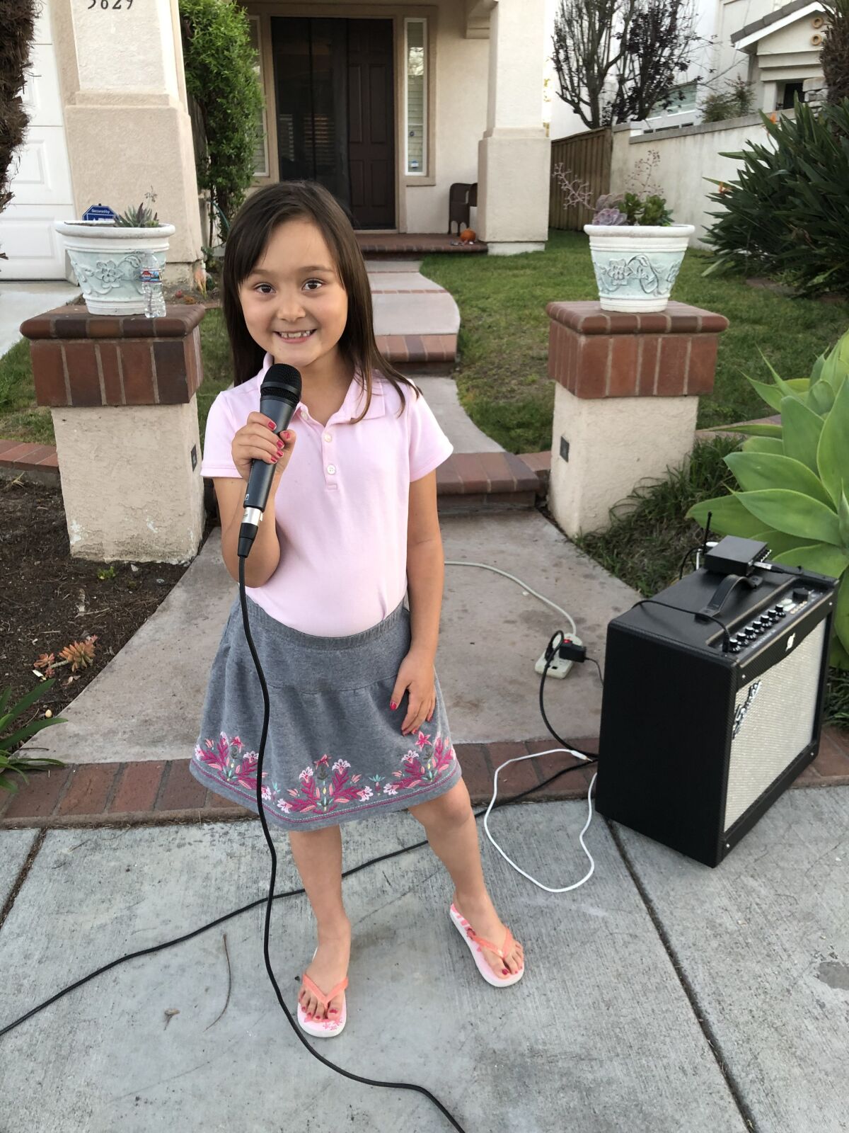 Eva Mather is performing songs for her neighbors during the stay-at-home order.