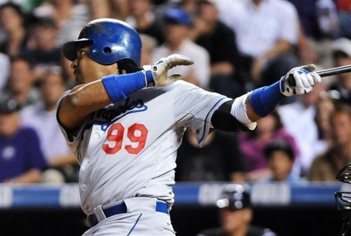 Los Angeles Dodgers left fielder Manny Ramirez tosses his glove