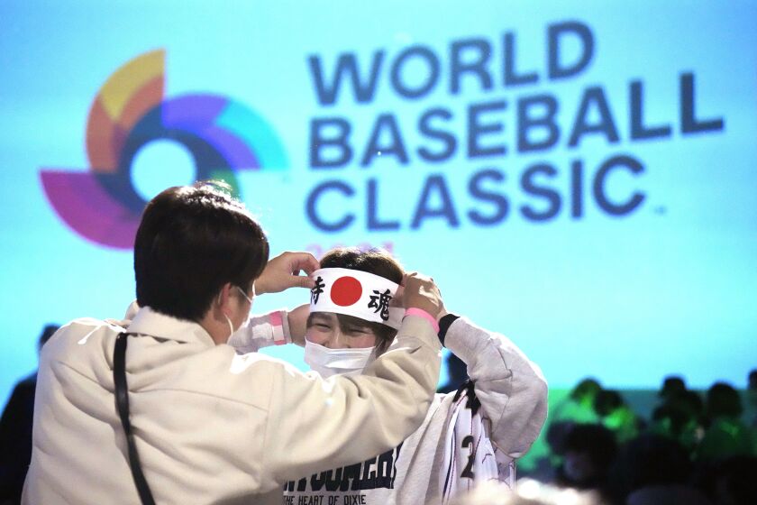 One of Japan fan prepares to cheer their them before they watch on a live stream of a World Baseball Classic (WBC) final between Japan and United States being played at LoanDepot Park in Miami, during a public viewing event Wednesday, March 22, 2023, in Tokyo. (AP Photo/Eugene Hoshiko)