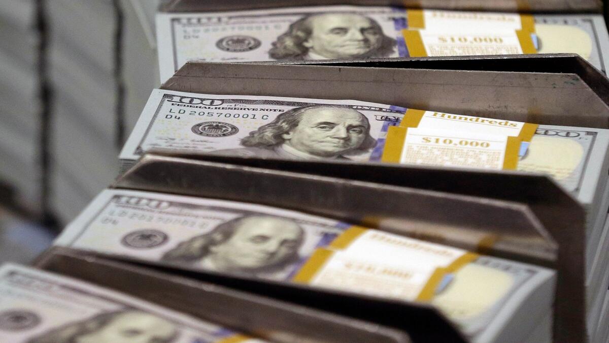 Freshly cut stacks of $100 bills at the Bureau of Engraving and Printing Western Currency Facility in Fort Worth, Texas.