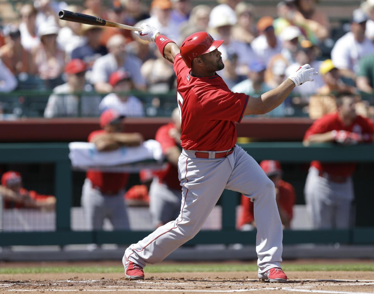 Angels first baseman Albert Pujols smacks a first inning home run off Giants ace Madison Bumgarner in a spring training game.