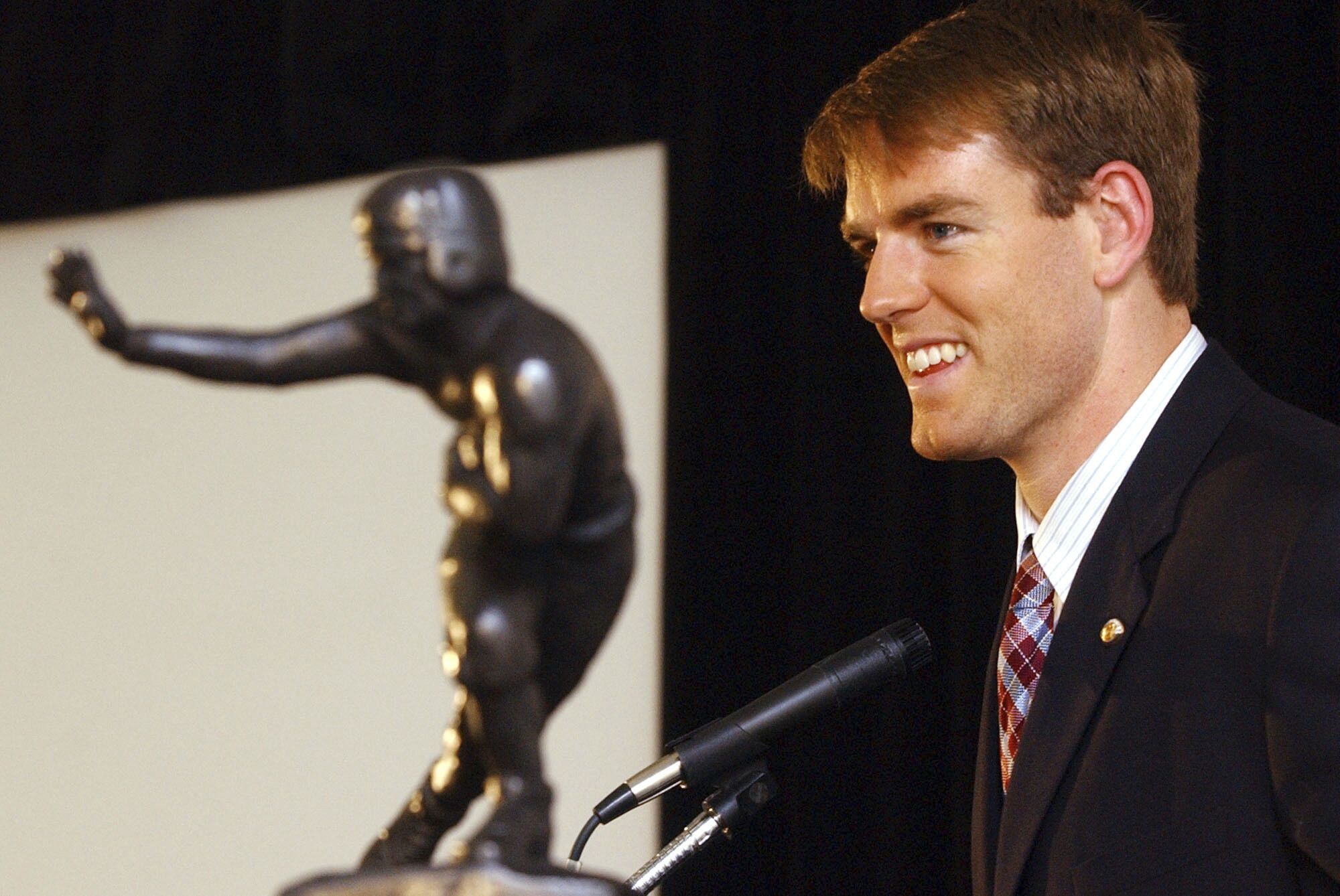 USC quarterback Carson Palmer poses with the Heisman Trophy in New York after winning the award in 2002.
