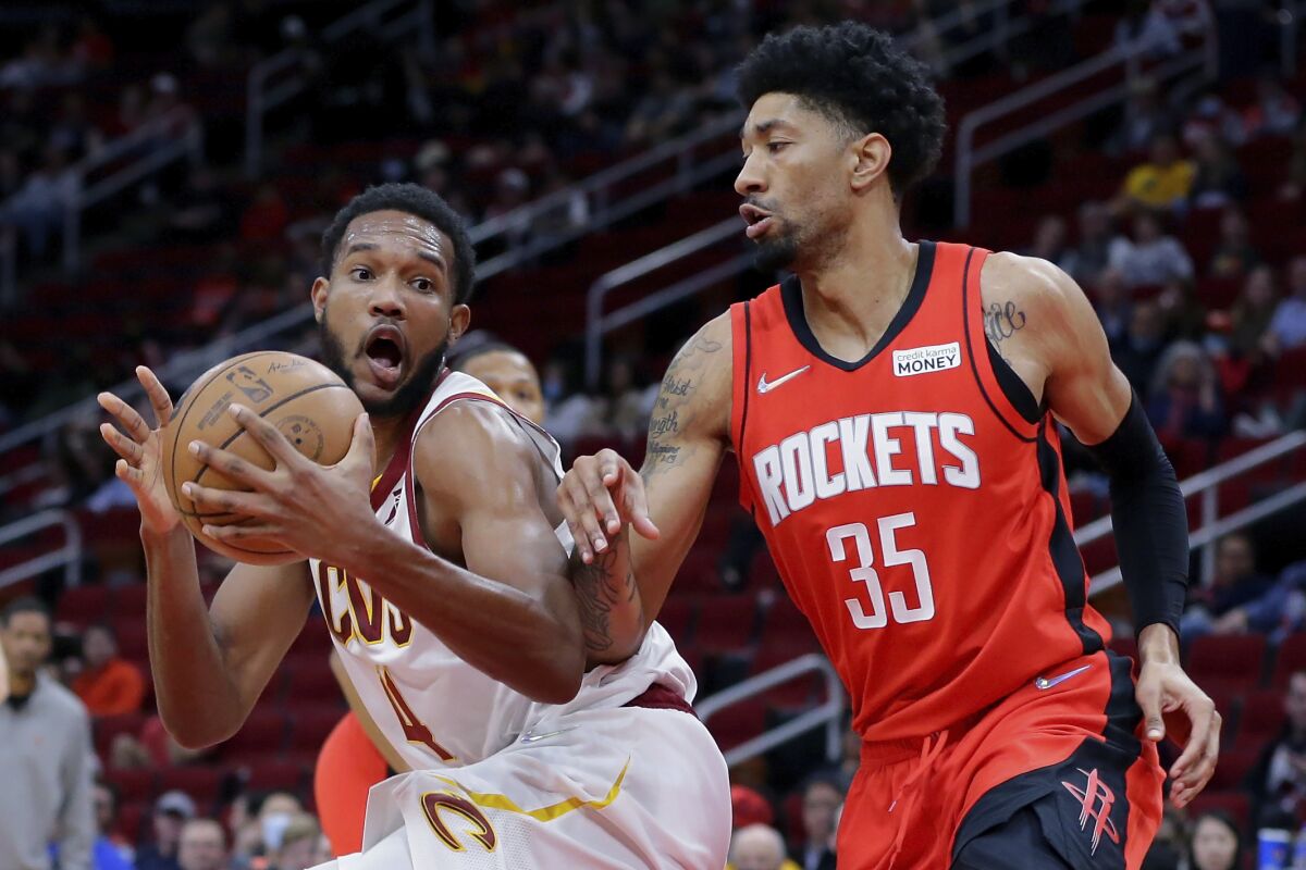 Cleveland Cavaliers center Evan Mobley (4) is defended by Houston Rockets center Christian Wood (35) during the first half of an NBA basketball game Wednesday, Feb. 2, 2022, in Houston. (AP Photo/Michael Wyke)