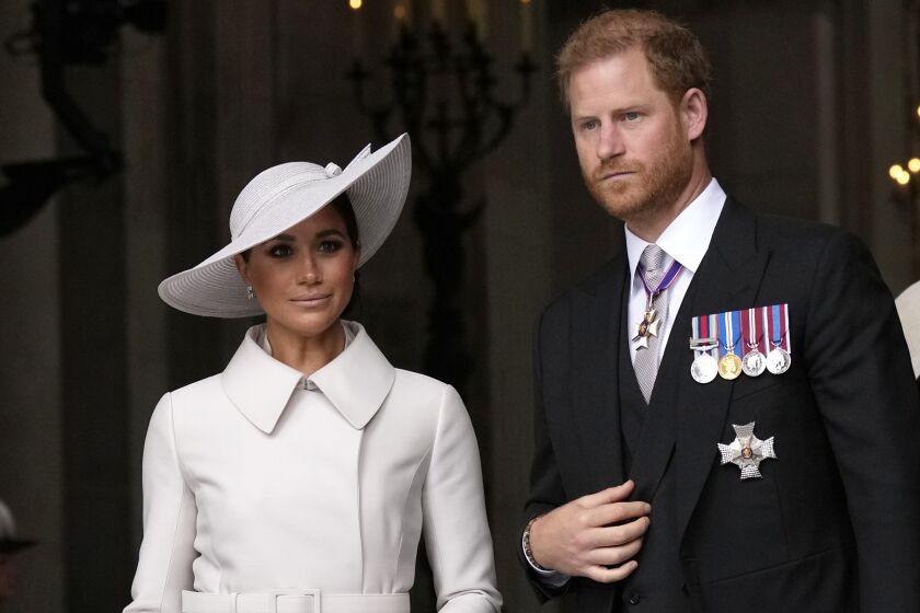 FILE - Prince Harry and Meghan Markle, Duke and Duchess of Sussex leave after a service of thanksgiving for the reign of Queen Elizabeth II at St Paul's Cathedral in London, Friday, June 3, 2022. The Duke of Sussex is scheduled to testify in the High Court after his lawyer presents opening statements Monday, June 5, 2023 in his case alleging phone hacking. It’s the first of Harry’s several legal cases against the media to go to trial and one of three alleging tabloid publishers unlawfully snooped on him. (AP Photo/Matt Dunham, Pool, File)