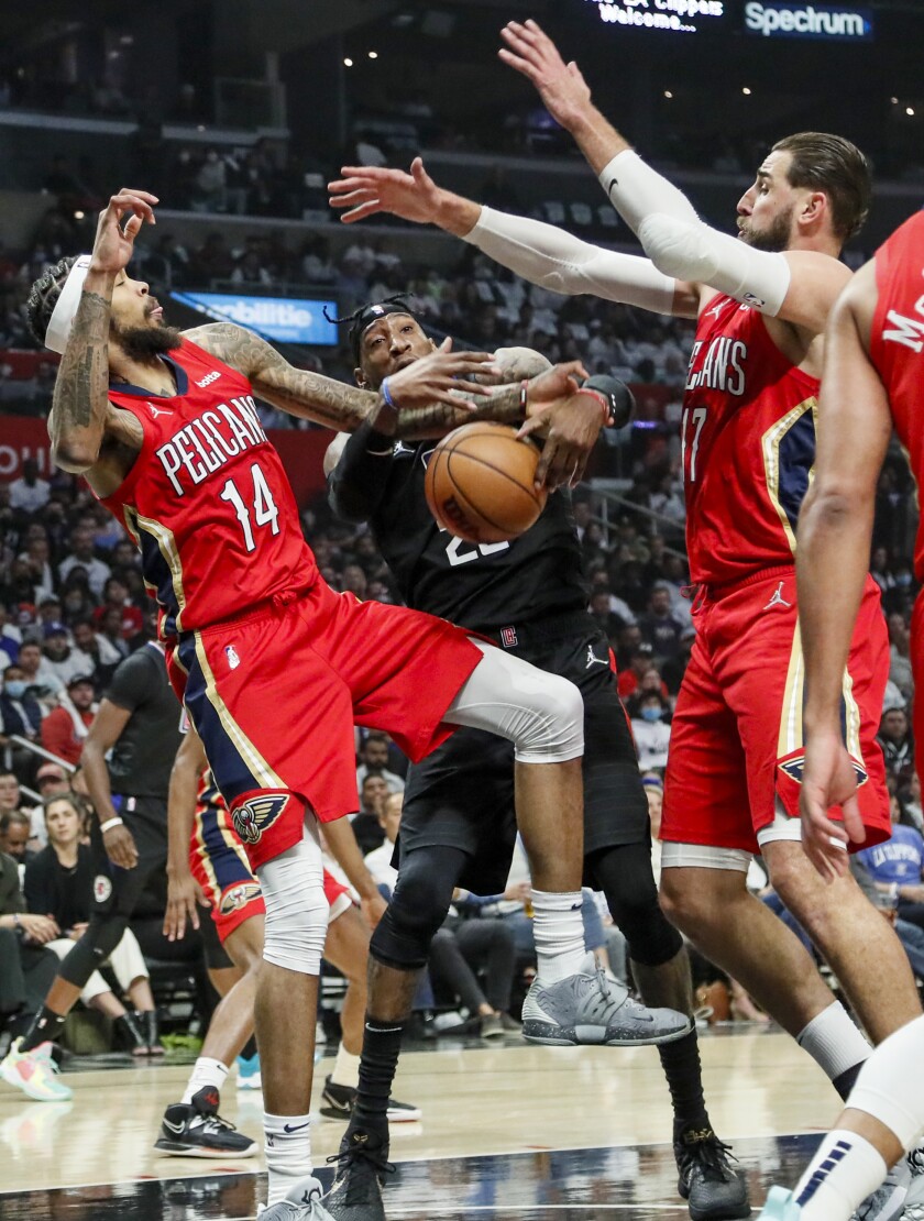 Clippers forward Robert Covington (23) battles Pelicans forward Brandon Ingram (14) for a rebound.