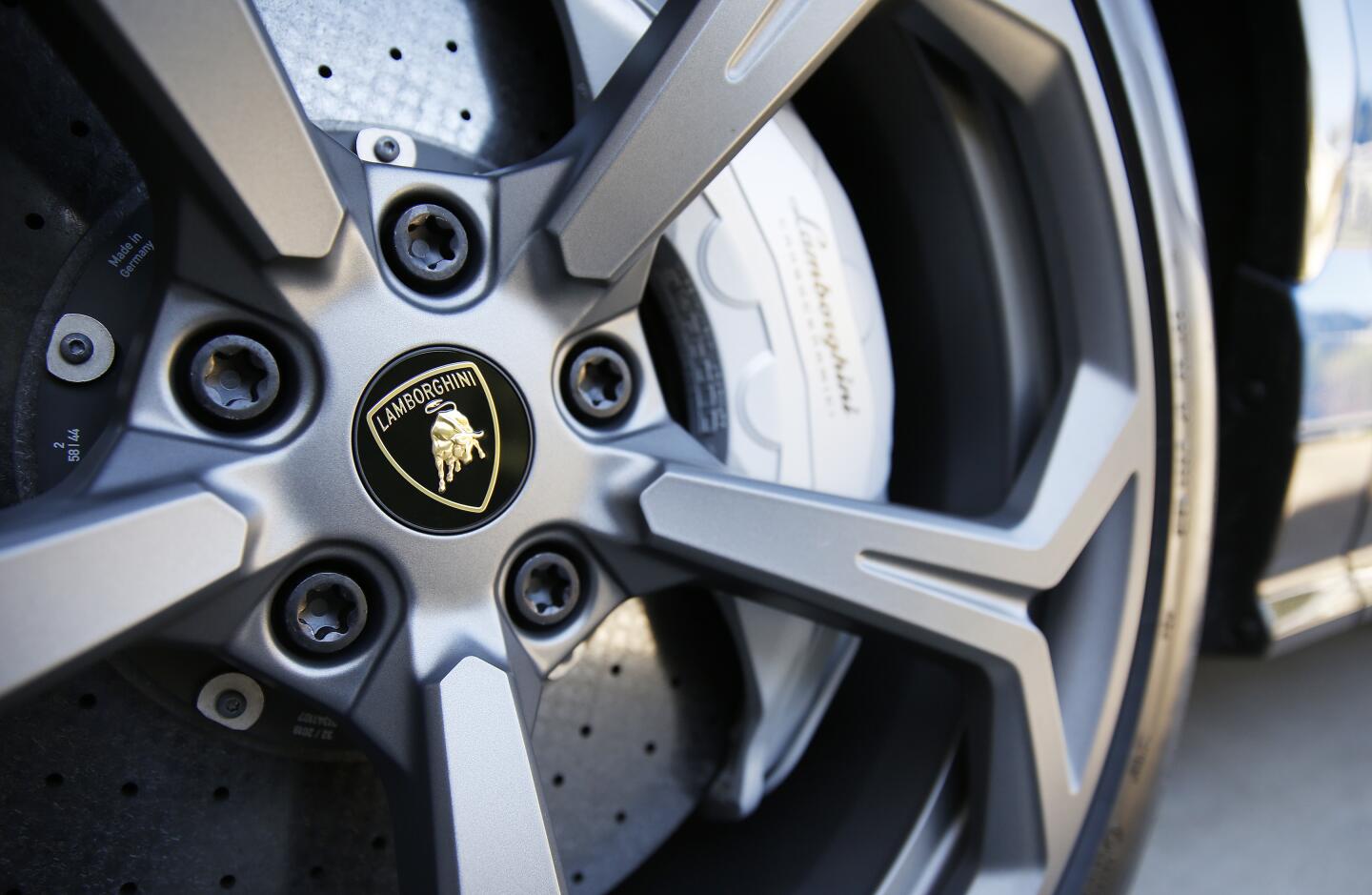 A tire with the Lamborghini logo in the center of the hubcap.