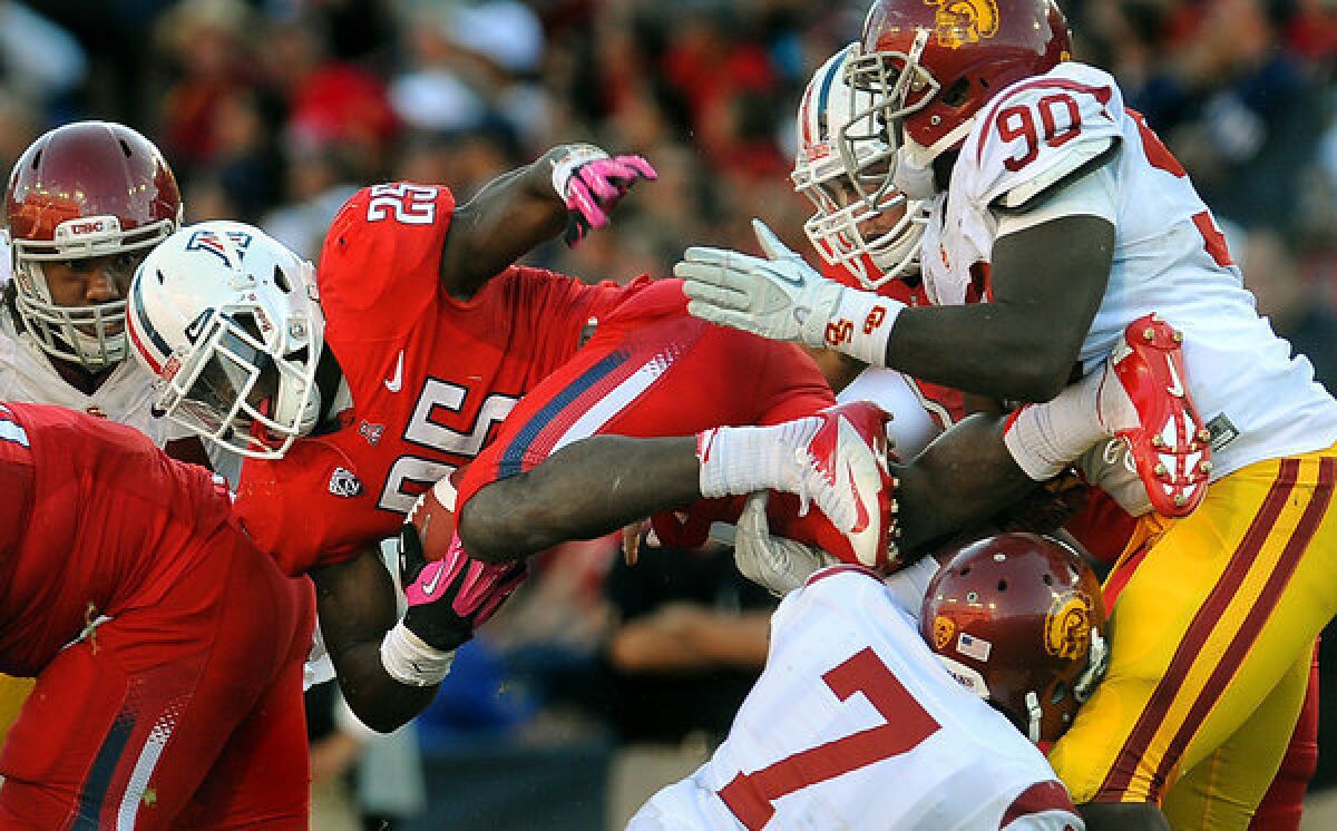 Arizona running back Ka'Deem Carey picks up a first down against USC late in the fourth quarter Saturday.