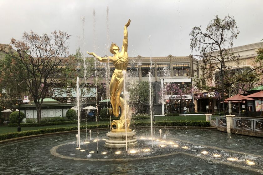 Most stores in the Americana might be closed, but the outdoor mall's fountain continues to "dance" to timeless classics.