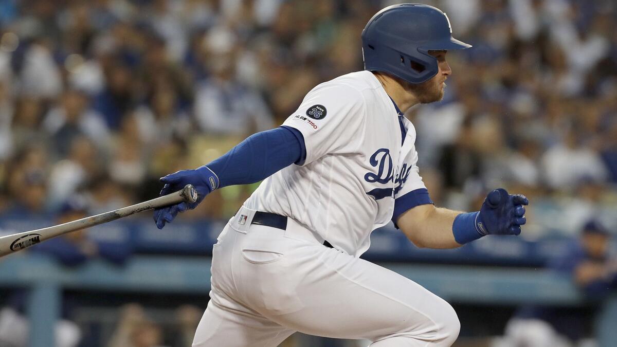 Dodgers secod baseman Max Muncy hits a single against the San Francisco Giants to drive in Kike Hernandez in the first inning on Thursday at Dodger Stadium.