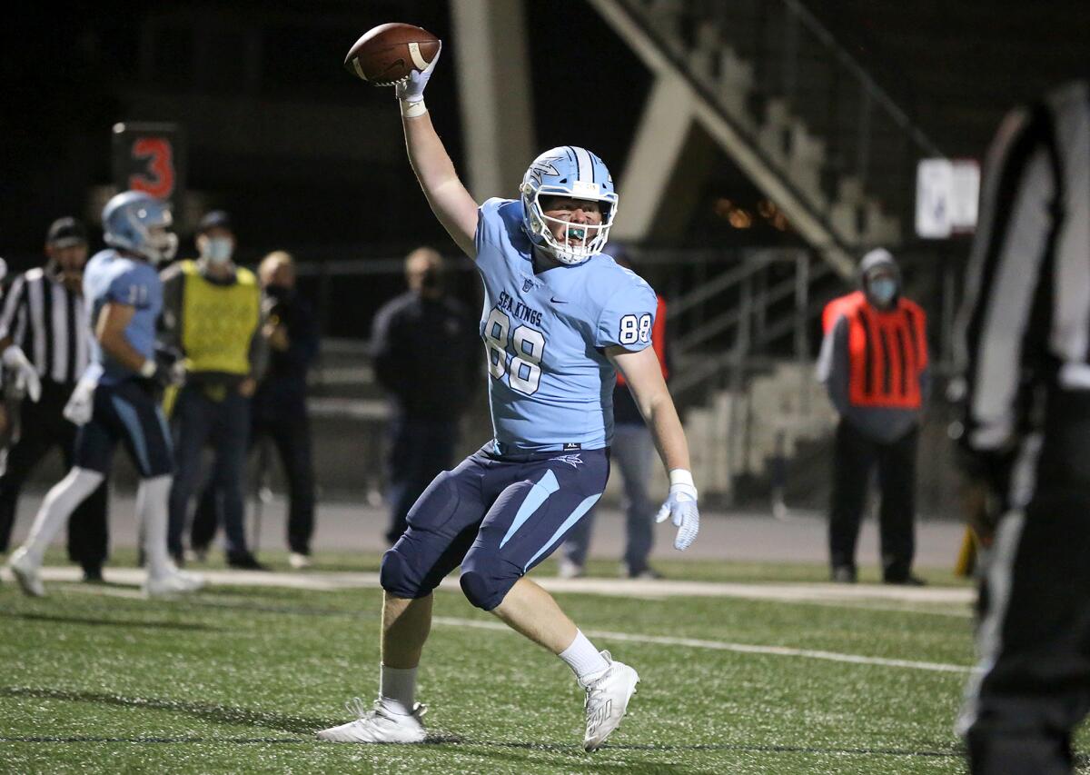 Corona del Mar's Trent Merriman scores a touchdown after a throw by quarterback David Rasor against Huntington Beach.