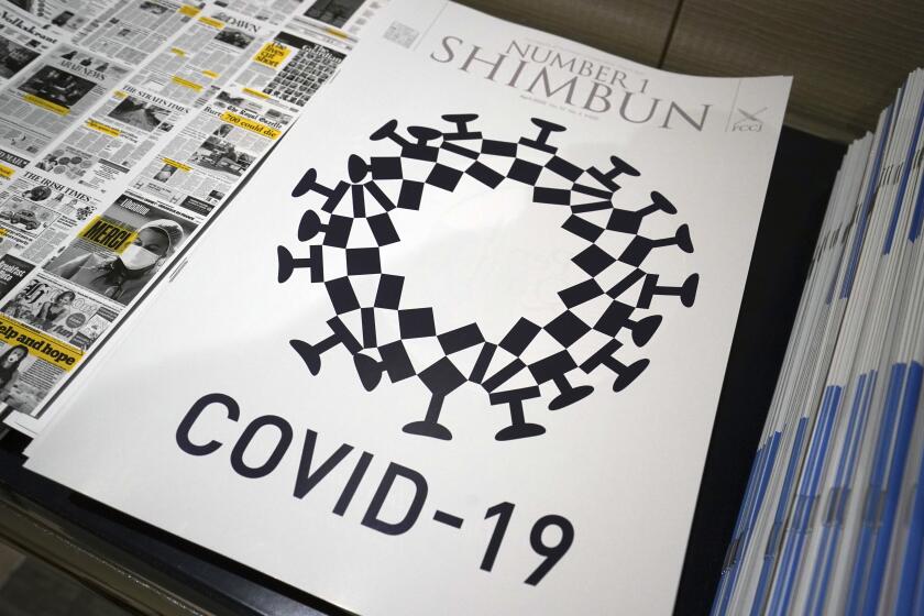 The cover design of Number 1 Shimbun is seen in Tokyo, Tuesday, May 19, 2020. Tokyo Olympics officials are incensed that their games emblem has been used in the cover design of the local magazine that combines the logo with the novel coronavirus. The “look-alike”emblem, which had “COVID-19” written underneath, was published on the cover the the April issue of the Foreign Correspondents Club of Japan's magazine. It also appeared in an online edition. (AP Photo/Eugene Hoshiko)
