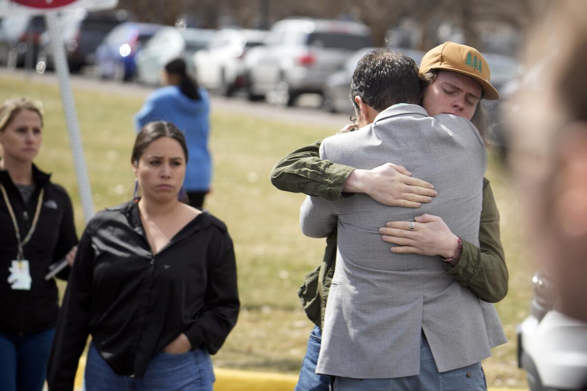 A student hugs a parent as they are reunited following a shooting.