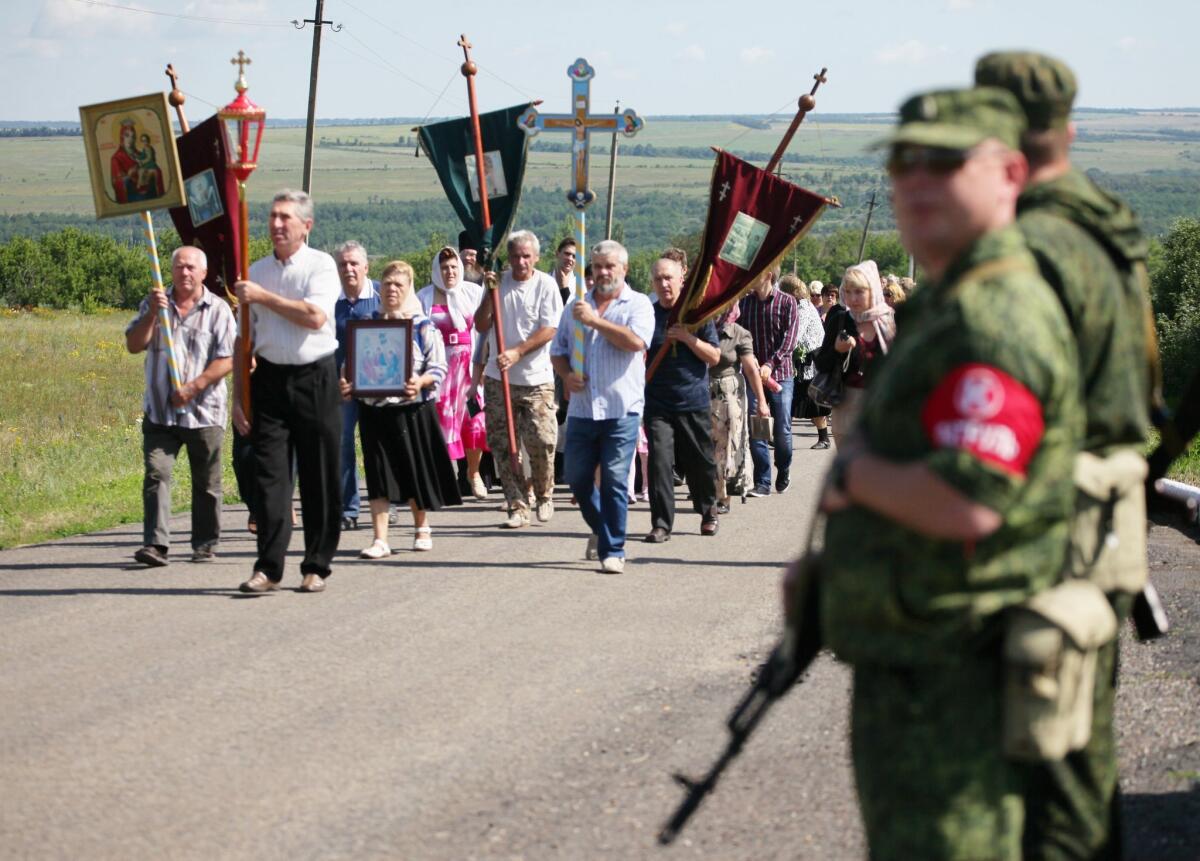 About 200 Ukrainian villagers marched near Grabove on Friday in memory of those killed a year earlier when Malaysia Airlines Flight 17 was shot down over the separatist-held farming town in eastern Ukraine.