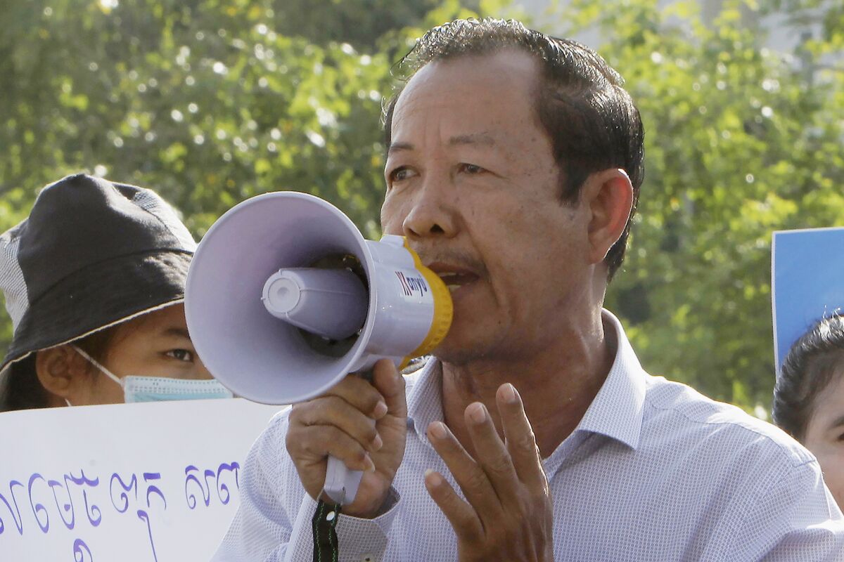 FILE - In this July 29, 2020, file photo, Rong Chhun, president of the Cambodian Confederation of Unions, uses a megaphone during a protest near the prime minister's residence in Phnom Penh, Cambodia. A Cambodian appeals court on Friday, Nov. 12, 2021, ordered the early release of five activists, including ong Chhun, a prominent labor leader who has been a longtime critic of the government. (AP Photo/Heng Sinith, File)