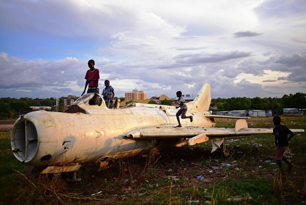 Children play on a destroyed fighter plane in Juba, the capital of South Sudan, on April 21.