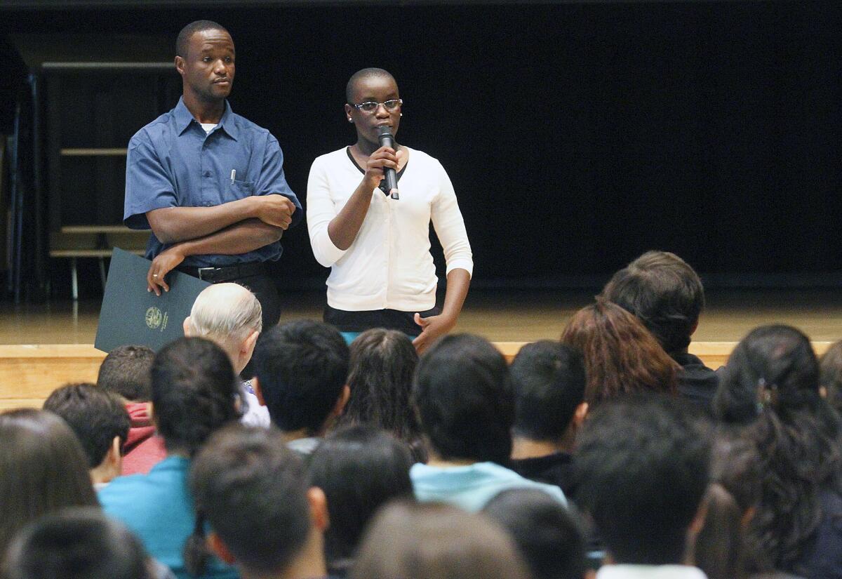 Chess champion Phiona Mutesi, of Uganda, talks with students, answering questions, with her coach Robert Katende at Clark Magnet High School in Glendale on Monday, April 25, 2014. Mutesi grew up in the slums of Uganda and through the game of chess has lifted herself out of the slums onto the international stage for chess and to raise awareness about the plight of her Ugandan people. After her presentation for the students of Clark Magnet, she played against local chess grandmaster Tatev Abrahamyan, of Glendale.