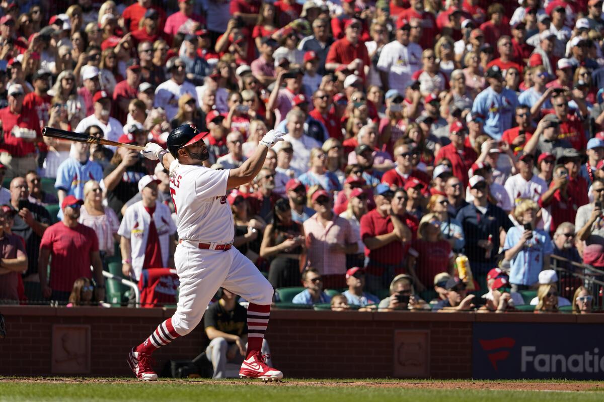 St. Louis Cardinals' Albert Pujols follows through on a solo home run during the third inning of a baseball game against the Pittsburgh Pirates Sunday, Oct. 2, 2022, in St. Louis. (AP Photo/Jeff Roberson)