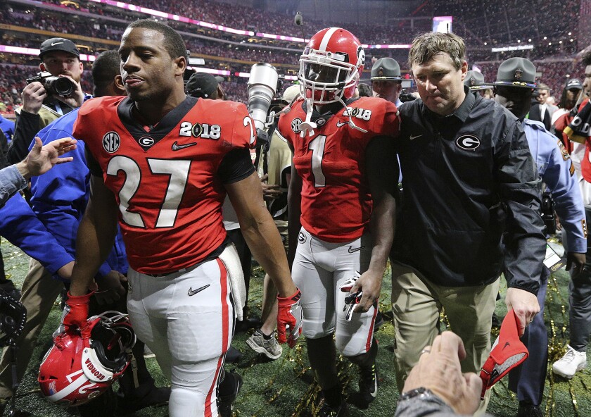 FILE - Georgia's Nick Chubb, from left, Sony Michel and Kirby Smart walk off the field as Georgia loses to Alabama in the NCAA college football playoff championship game in Atlanta on Monday, Jan. 8, 2018. Alabama won, 26-23. Those Georgia Bulldogs aren't the only ones having a devil of a time beating fellow Southeastern Conference powerhouse Alabama. (Curtis Compton/Atlanta Journal-Constitution via AP, File)