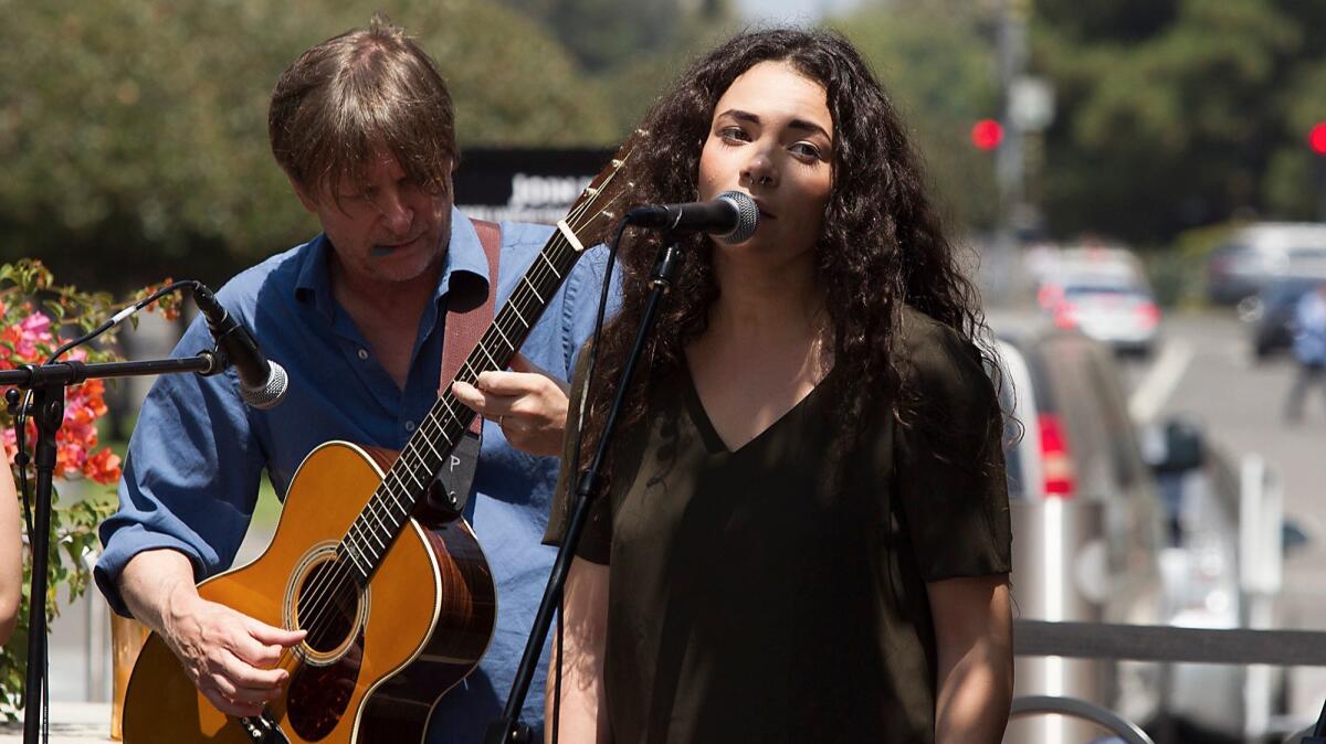 Amanda Leigh Jerry sings as she and fellow cast members from "Once" perform during a noontime concert in front of South Coast Repertory on Aug. 23.