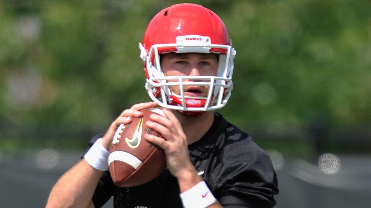 Georgia quarterback Hutson Mason drops back to pass during a practice session on Aug 1. Mason has waited patiently for his chance to lead the Bulldogs' offense.