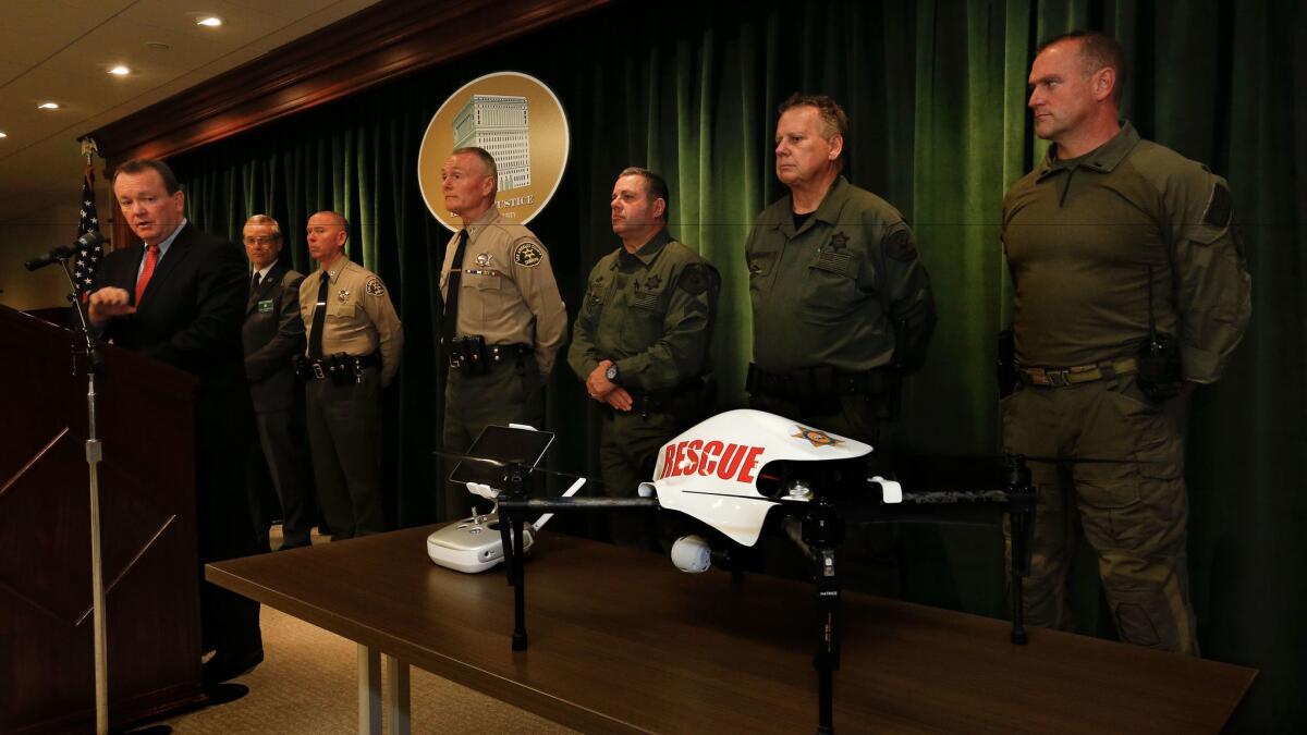 Los Angeles County Sheriff Jim McDonnell, left, introduces the department's new unmanned aerial vehicle, which will be used to aid deputies responding to suspicious packages and hazardous material incidents, among other situations.