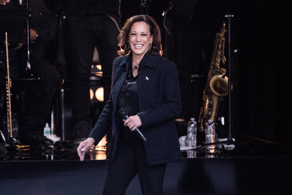 Vice President Kamala Harris holding a microphone