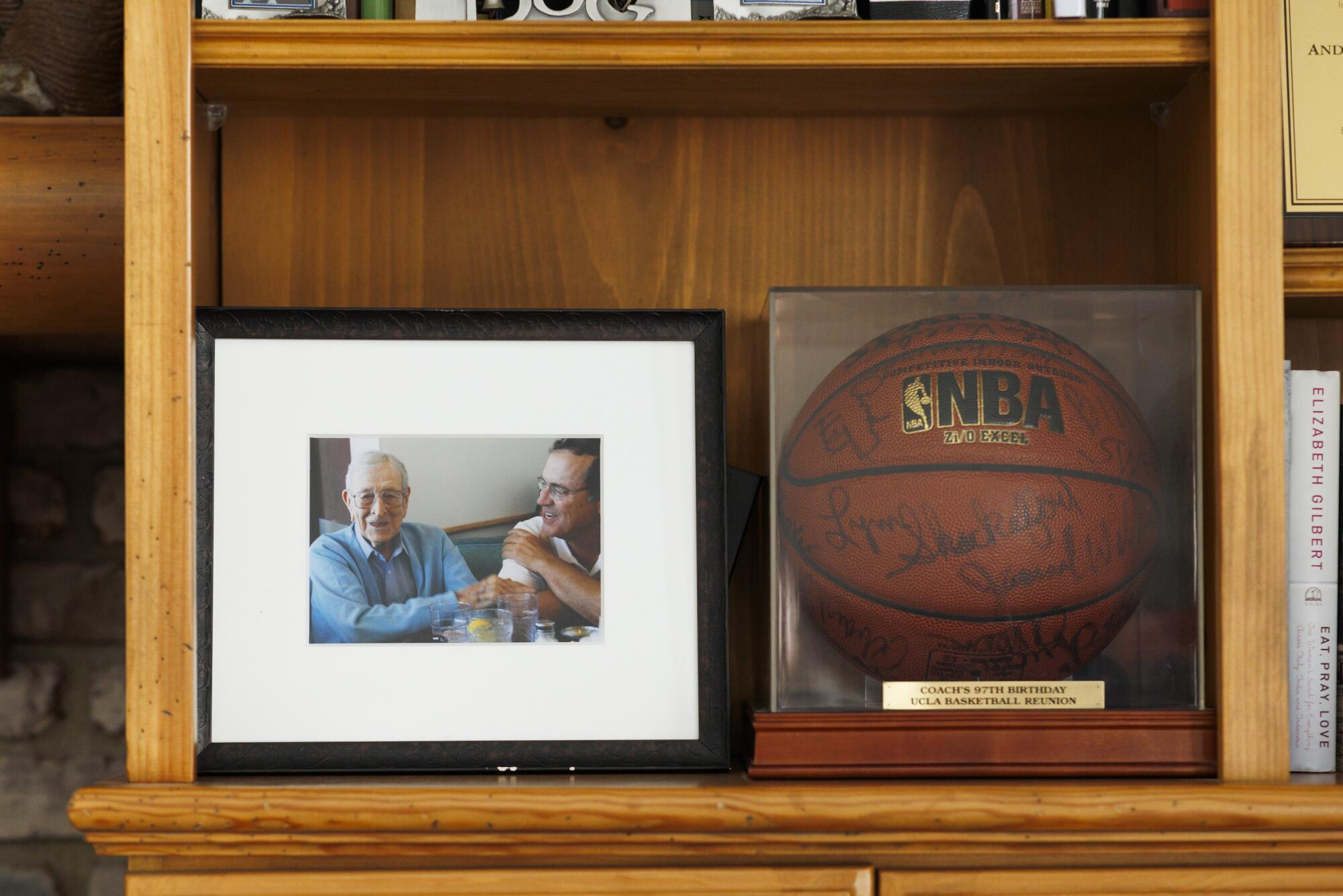 How UCLA's Andy Hill spawned the plus-minus stat, an ode to group play and John Picket 4 Andy Hill displays a photo with UCLA coach John Wooden and a basketball signed by Bill Walton in his home.