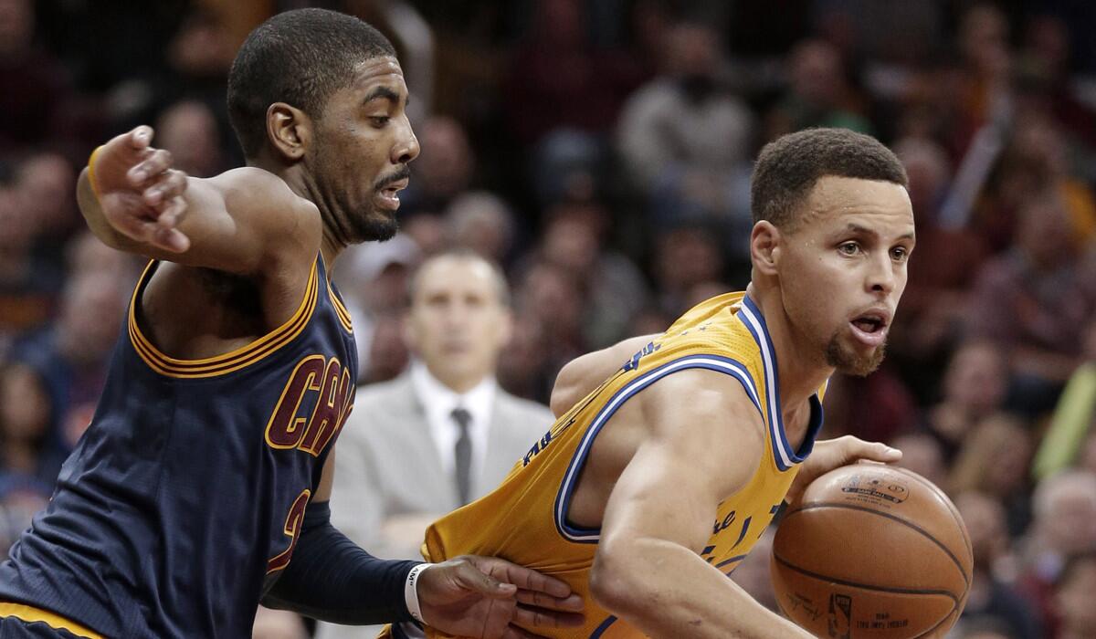 Golden State Warriors’ Stephen Curry, right, drives past Cleveland Cavaliers' Kyrie Irving in the second half on Monday.