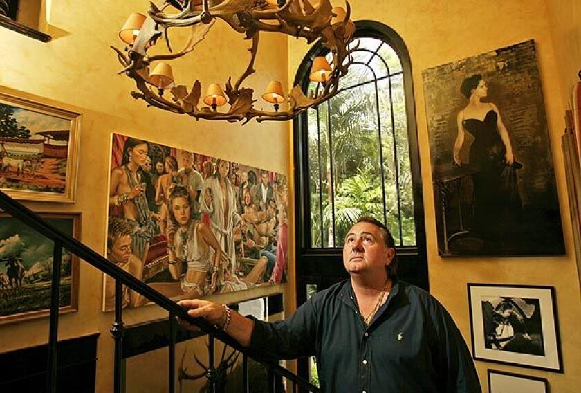 Turner eyes an antler chandelier in the foyer, which features an eclectic mix of artwork: vintage cowboy paintings, black-and-white photos and contemporary pieces. The large Terry Rodgers painting of a Hollywood party, shown next to the window, served as artwork for Flaunt magazines August 2003 cover. Turner and Barajas are cofounders of the monthly fashion and culture magazine.
