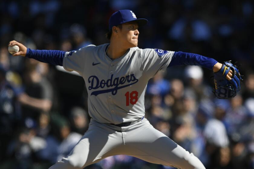 Los Angeles Dodgers starter Yoshinobu Yamamoto delivers a pitch during the first inning.