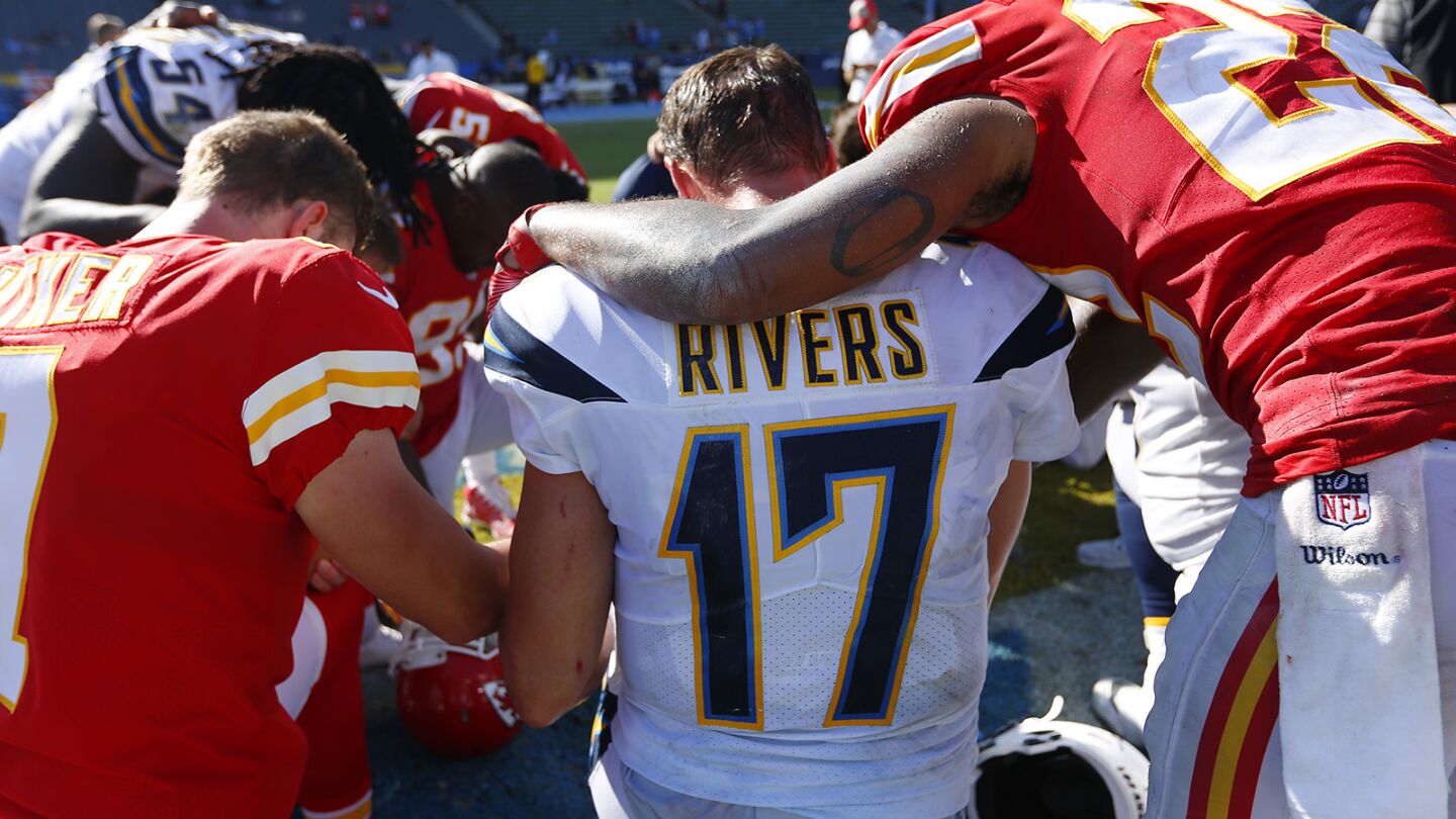Los Angeles Chargers quarterback Philip Rivers prays with Kansas City Chiefs players after a game at the StubHub Center in Carson on Sept. 9, 2018.
