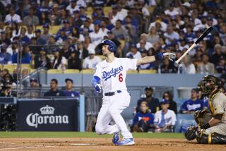 Los Angeles, CA - October 11: Los Angeles Dodgers' Trea Turner tosses his bat.